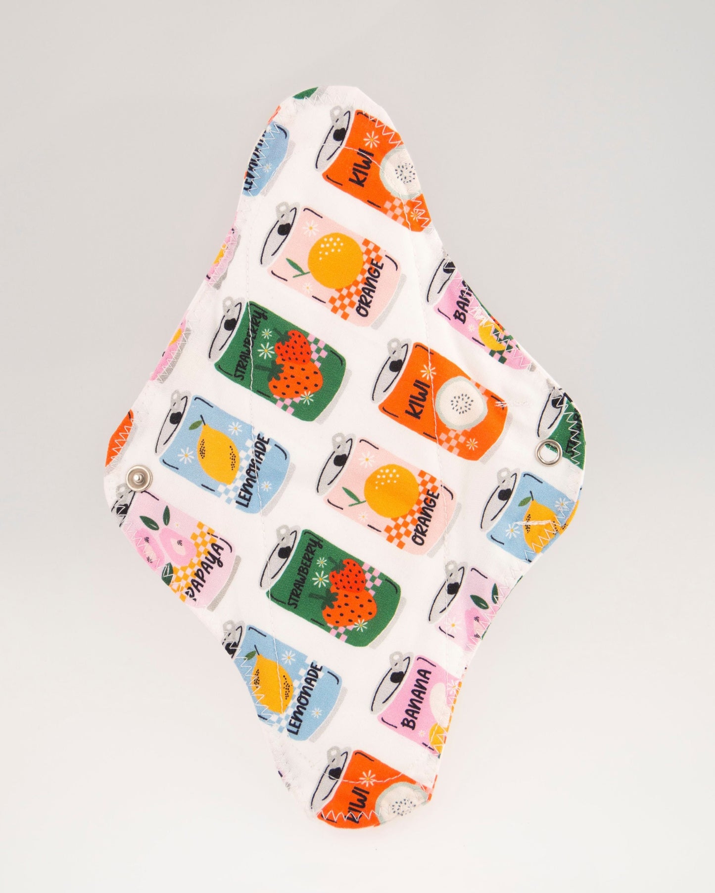 Compresa de doble tela con estampado de latas de distintos colores