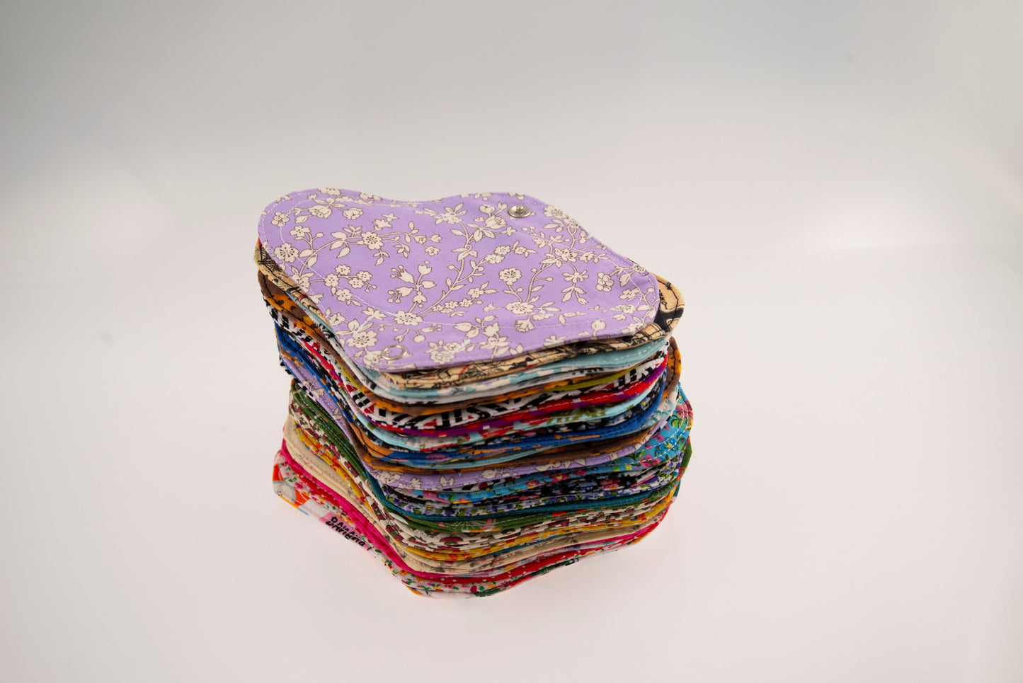 Montón de compresas salvaslip de tela de diferentes colores de Teixint Cicles