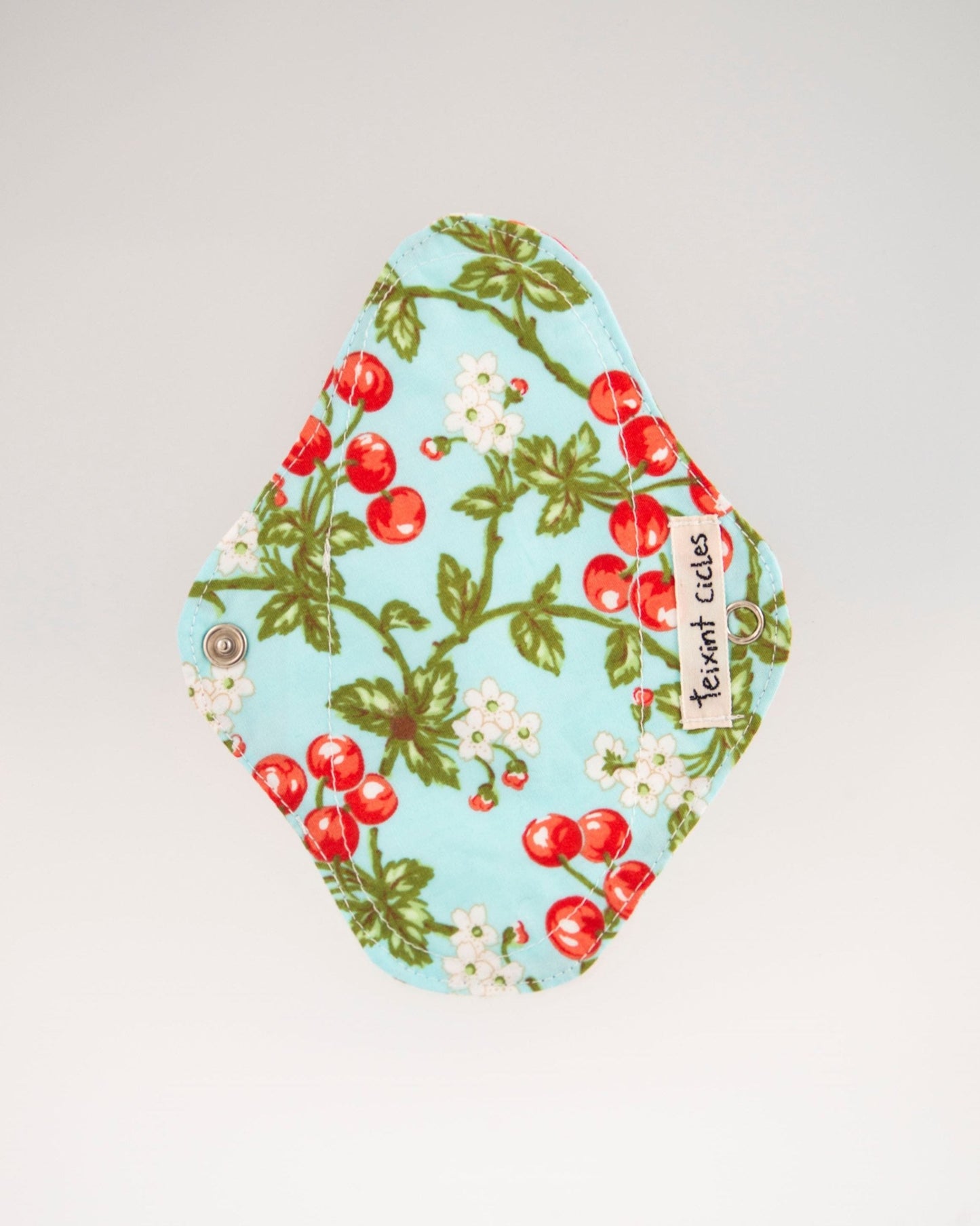 Compresa salvaslip reutilizable de tela con estampado de cerezas